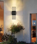15 Inch LED Up And Down Outdoor Wall Light With Aluminum Housing 18W 4000K Day White IP65 Waterproof Exterior Wall Mount Lamp 1800 Lumens Bright Durable Patio Porch Garden Lighting mounted beside a door.