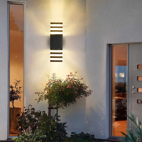 15 Inch LED Up And Down Outdoor Wall Light With Aluminum Housing 18W 4000K Day White IP65 Waterproof Exterior Wall Mount Lamp 1800 Lumens Bright Durable Patio Porch Garden Lighting mounted beside a door.