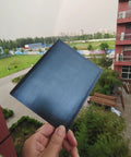 Ultra Thin Flexible CIGS Solar Panel Charger For Portable Power On The Go held in hand, urban background, 6.69x5.51 Inches size