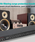 Badass 1U Rack Mount Power Conditioner With Eight Individually Switched Outlets Heavy Duty Surge Protection Led Voltage Display Smart Sequencing For Pro Audio And Data Racks in a studio setting with speakers.