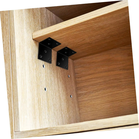 Built Tough Iron Corner Brackets For Cabinet Repair With Included Screws For Quick Diy Fixes No Sweat Power Drill Install For Shelves And Tables Slick Black Heavy Duty L Bracket Shelf Support Hardware Pack attached to a wooden shelf.