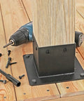 Beefed Up Heavy Duty 4x4 Post Base Bracket Set With 3.3 By 3.5 Inch Inner Size installed on wooden deck with mounting holes visible
