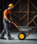 Worker pushing wheelbarrow with yellow Universal 4.80/4.00-8 Pneumatic Tire And Wheel Assembly 16 Inch for carts and wagons.
