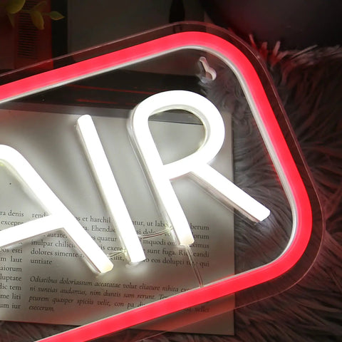 "AIR" neon sign in white and red glow, detail view with fluffy background, showcasing vibrant design