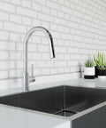 Modern kitchen with Stellen Kitchen Sink Faucet With Pull Down Sprayer, High Arc Chrome Finish, installed on a white countertop.