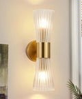 Modern Wall Sconce, Hardwired Wall Lamp for Bedroom Hallway Bathroom, Gold with frosted glass shade and metal base mounted on wall.