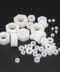 500 Piece Metric Nylon Hex Nuts Assortment Kit Featuring M2 Through M12 White Plastic Threaded Fasteners on a black background.