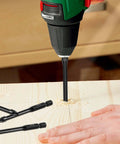Tile drill bit set with 1/4 inch hex shank, 6 mm masonry bits; drill in use with two bits on wood.