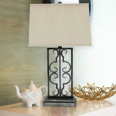 Metal Table Lamp With A Stacked Rectangular Base, Dope Scrollwork, And A Rectangular Shade For Modern Home Decor on table