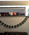Bold Black Skull Garland Decorations For Halloween And Gothic Parties Edgy Horror Banner Decor Perfect For Haunted Houses Pirate Themed Nights Rock And Metal Venues Dark Aesthetic Events hanging across a wall