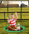 Child and dog sitting on 24 Inch Saucer Tree Swing Set For Kids And Adults, Adjustable Backyard Or Outdoor Playground Swing, Green And Black