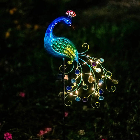 Metal Peacock Garden Solar Lights Outdoor Stake Waterproof Led Path Light For Patio Yard And Lawn Decor Charming Peacock Figurine With Warm String Lights For Cozy Nighttime Ambience, illuminated with LEDs in a garden setting.