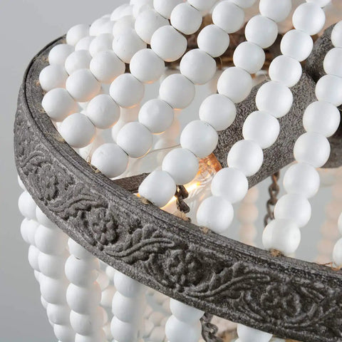 Close-up of Three Light Boho Wood Beaded Chandelier With White Finish Pendant Light detailing beads and chain.
