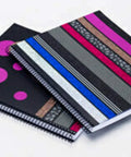 Two spiral notebooks with decorative covers in black and colorful washi tape design, showcasing creative uses for Black Stripe Washi Craft Tape.
