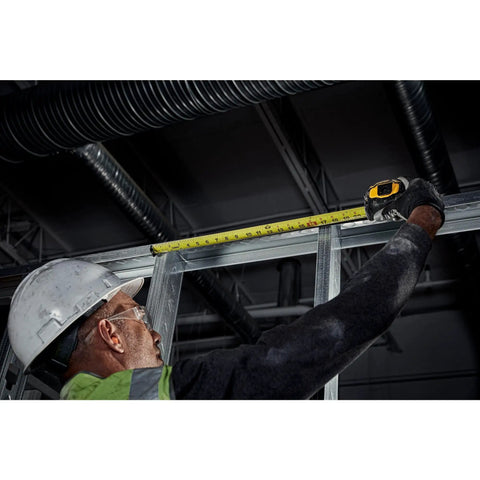 Worker using Tough Series 25 Ft Tape Measure With Magnetic Clip And Double Sided Blade Pro Grade Heavy Duty Housing Extend Reach