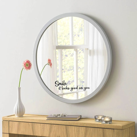 Round mirror with 'Smile It Looks Good On You' decal, next to vase and candles, Smile It Looks Good On You Mirror Sticker Vinyl Glass Decals Waterproof