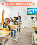 Children in classroom with 40 Piece Waterproof Desk Nameplates For Classroom Use Kid Friendly Multipurpose Name Tags on desks