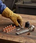 Pro Grade Torch Consumables Kit With Cutter Nozzles Electrodes Retaining Cap Insulating Cap And Washers, Heavy Duty Spare Parts For Fabrication Shops, Repair Garages, And Home Workshops, copper nozzles and electrodes on workbench