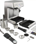 Pro Level Espresso Machine With A Rock Solid Steam Wand For Silky Microfoam And Volumetric Shot Control In Heavy Duty Brushed Stainless Steel Frame with accessories laid out.