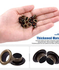 Hand holding 200 pcs 6mm bronze grommet eyelets with washers for fabric, canvas, curtain, leather repair, durable thickened metal grommets.