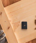 Set Of 5 M6 Thread Aluminum Alloy Sliders For Mounting Woodworking Equipment, black piece on wooden surface with dowels