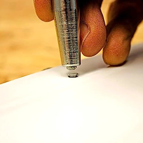 Using Pro Grade Trim Nail Driver With Hardened Steel Punch to drive nail into soffit, showing no dent finishing and smooth action.