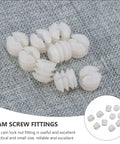 Close-up of cam screw fittings from Cam Lock Fasteners Connector Set including 32 plastic dowels for cabinet assembly.