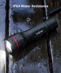 Beastly Bright LED Flashlight With Zoomable Beam And Five Modes High Medium Low SOS And Flash Waterproof Pocket Size lying wet on a wooden surface, IPX4 water resistance displayed.