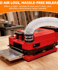 Magnetic Dust Collection Fittings For Woodworking Shops With Quick Hose Connectors attached to red planer on workbench
