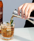 Hand pouring liquid using Double Head Cocktail Jigger For Bartending With Inside Measurements Japanese Grade 304 Stainless Steel Barware