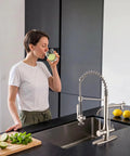 GIMILI 3 in 1 Commercial Kitchen Faucet with Water Filter System in brushed nickel, woman drinking water with lemon.