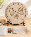 Custom DIY Family Handprint Stone Kit With Concrete Mold, Letter And Number Stamps, Colorful Gems For Indoor Outdoor Garden Keepsake Craft, Hands On Fun To Create Personalized Handprint Memorial Gift For Kids And Parents displayed on a table.