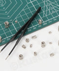 101 Piece M2 To M6 Heat Set Threaded Inserts Kit With Tweezers For Plastic And 3D Printing, 303 stainless steel, on cutting mat