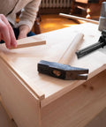 Dead On Precision Carpentry Scriber Mortise Marking Gauge on a wooden surface with a hammer for woodworking projects.