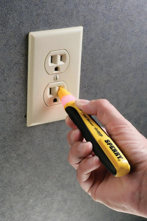 Straight Up Tough Non Contact Voltage Detector 50 To 1000 Volt Ac used on electrical outlet with ergonomic grip in hand.