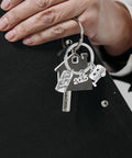 Travel Themed Camper Keychain Easy On Off Zinc Alloy Charm For RV Lovers And Outdoor Adventurers held by a hand