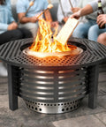 Fire Pit Surround Tabletop For Bonfire Nights, 37.5 Inch Outdoor Steel Table with fire, used by people for snacks and drinks.