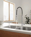 Precept Pull Down Kitchen Faucet With PowerInse Sprayer Chrome Finish in modern kitchen setting with dual sinks