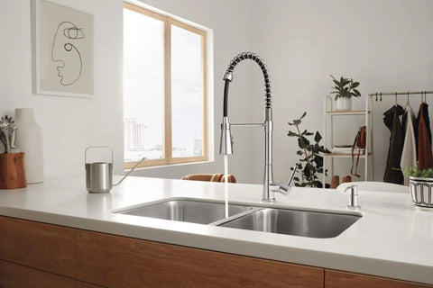 Precept Pull Down Kitchen Faucet With PowerInse Sprayer Chrome Finish in modern kitchen setting with dual sinks
