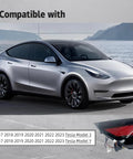 Slick Rear Left Charging Port Door Assembly For Tesla Model 3 And Model Y Years 2017 Through 2023 on a vehicle by water.