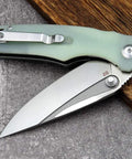 Fast Opening Ball Bearing Folding Knife with Pocket Clip D2 Steel Blade G10 Handle Jade Finish on table