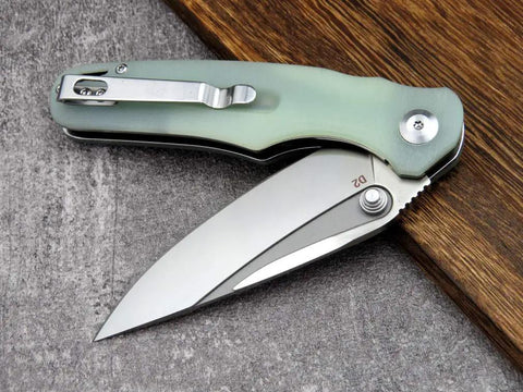 Fast Opening Ball Bearing Folding Knife with Pocket Clip D2 Steel Blade G10 Handle Jade Finish on table