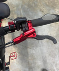 Close-up of handlebar with red brake lever from HB876E 4 Piston Ebike Hydraulic Disc Brake Set With Power Off Sensor 160mm Rotors