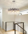 Dope Modern K9 Crystal Chandelier With Nine Lights Raindrop Pendant Ceiling Light Chrome Finish hanging in a modern room
