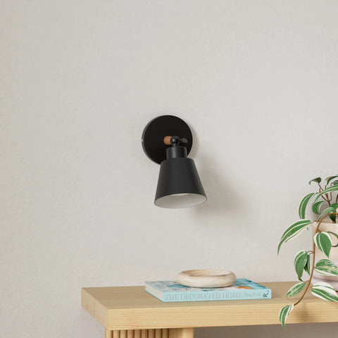 Black Wireless Led Wall Sconces Set Of Two With Remote Control Dimmer And Auto Timer Zero Drilling Hassle Straight Forward Battery Mount on a wall above a wooden table.