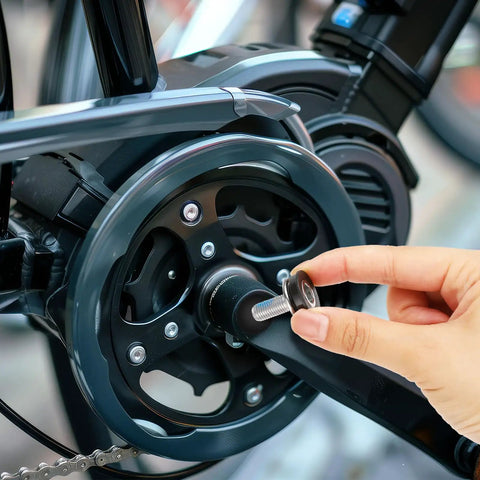 Person installing Six 8mm Hex Crank Arm Bolts With Caps For Square Cranksets, Durable Metal Construction on a bicycle.