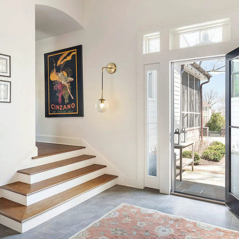Entryway with Mid Century Modern Wall Light With Adjustable Cord Raw Brass Round Glass Sconce and Amber Lampshade