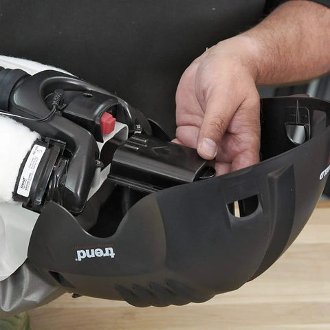 Close-up of hands handling battery pack in the Badass Powered Air Respirator And Hearing Protection Bundle For Woodworking Shops.