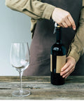 Person using Portable Orange Corkscrew Wine Opener Set For Waiters And Bartenders, Stainless Steel Wine Key with glass in view