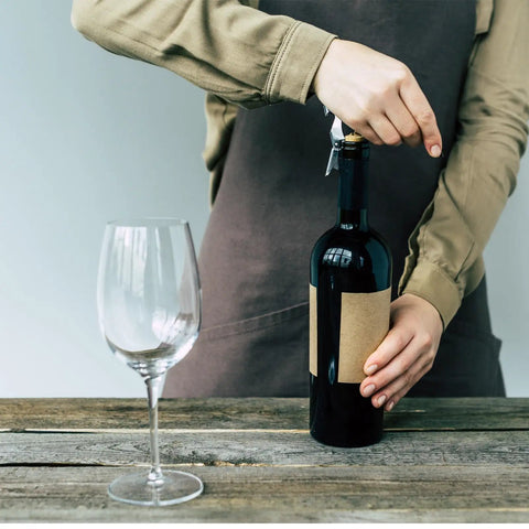 Person using Portable Orange Corkscrew Wine Opener Set For Waiters And Bartenders, Stainless Steel Wine Key with glass in view